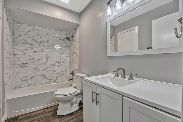 full bathroom with toilet, vanity,  shower combination, and wood finished floors