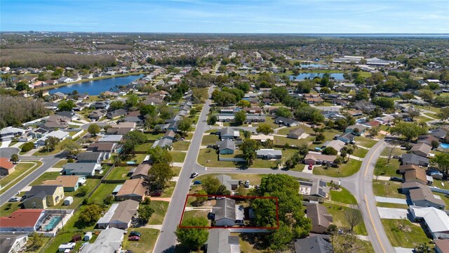 birds eye view of property featuring a water view and a residential view