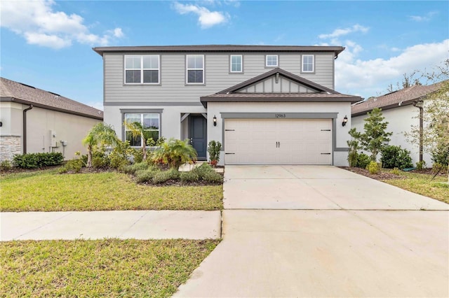view of front of property with concrete driveway, a front lawn, and stucco siding