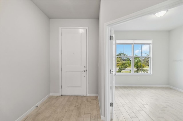 interior space featuring baseboards and light wood-style floors