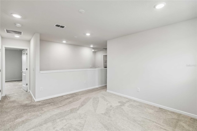 unfurnished room with visible vents, recessed lighting, baseboards, and carpet