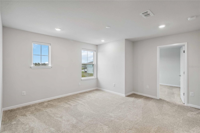 empty room with plenty of natural light, recessed lighting, baseboards, and carpet