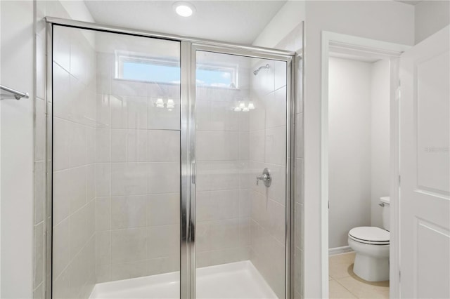 full bath with tile patterned flooring, a shower stall, and toilet