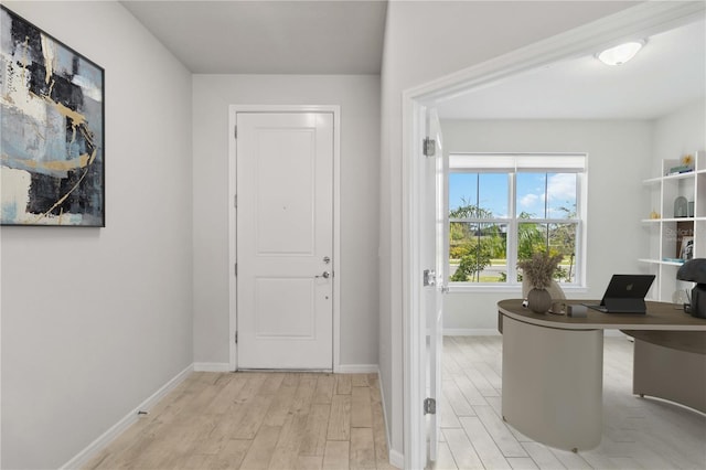 entryway featuring baseboards and light wood-style flooring
