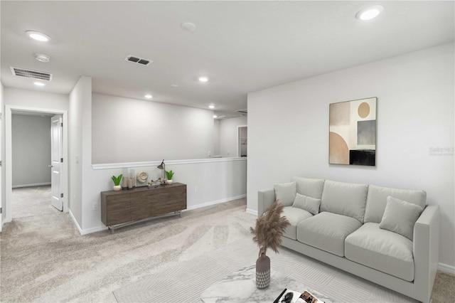 living area featuring visible vents and carpet