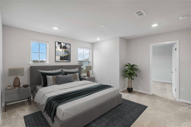 carpeted bedroom with visible vents, multiple windows, recessed lighting, and baseboards