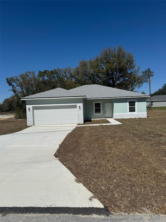 ranch-style house with stucco siding, concrete driveway, and a garage