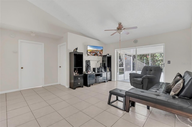 living area with a ceiling fan, a textured ceiling, light tile patterned floors, baseboards, and vaulted ceiling