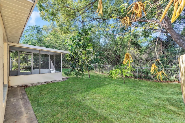 view of yard featuring a fenced backyard and a sunroom