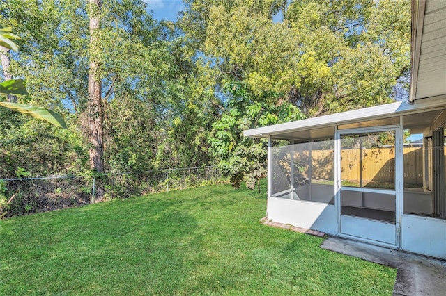 view of yard with a fenced backyard and a sunroom