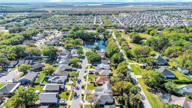 drone / aerial view featuring a residential view and a water view