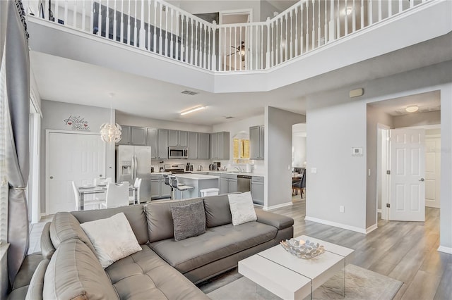 1028 Orange Cosmos Blvd, Davenport, FL 33837 - living room featuring light wood-style floors and a high ceiling