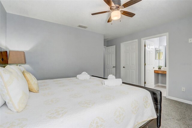 1028 Orange Cosmos Blvd, Davenport, FL 33837 - carpeted bedroom with connected bathroom and a ceiling fan