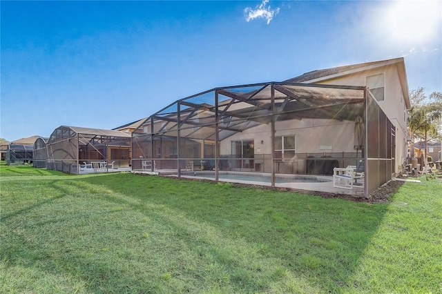 1028 Orange Cosmos Blvd, Davenport, FL 33837 - rear view of house with a lawn, stucco siding, an outdoor pool, and glass enclosure