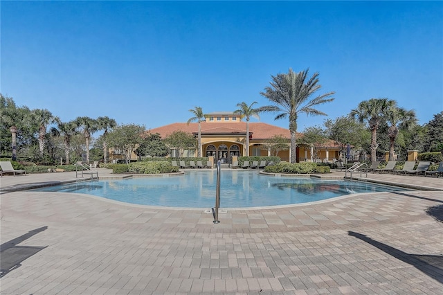 1028 Orange Cosmos Blvd, Davenport, FL 33837 - community pool featuring a patio