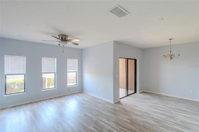 9620 Doris Ln, Orlando, FL 32829 - empty room with a chandelier, light wood-type flooring, a ceiling fan, and baseboards