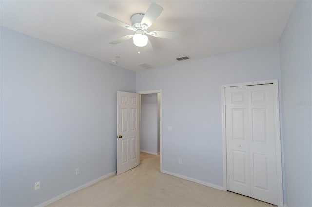 9620 Doris Ln, Orlando, FL 32829 - unfurnished bedroom featuring light colored carpet, baseboards, ceiling fan, and a closet