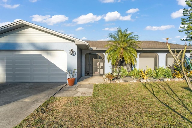 ranch-style home with concrete driveway, a garage, a front yard, and stucco siding