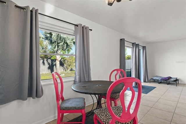 dining room featuring light tile patterned floors and baseboards