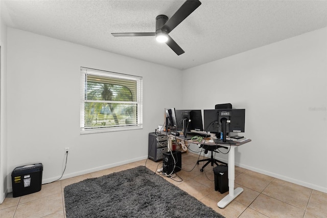 office area featuring baseboards, a textured ceiling, ceiling fan, and light tile patterned flooring