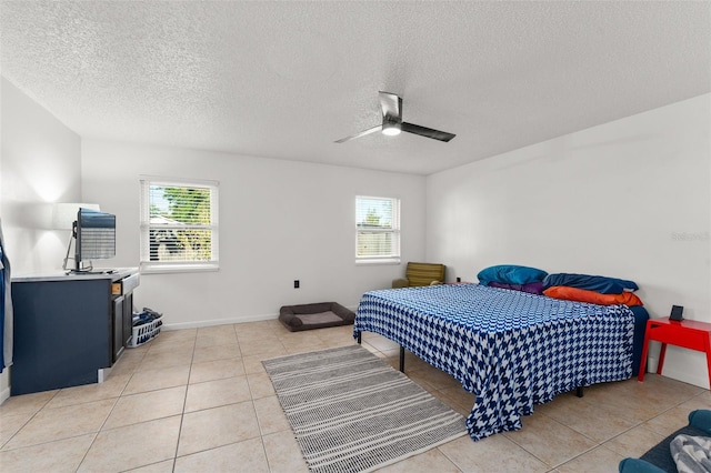 bedroom with a ceiling fan, multiple windows, and light tile patterned flooring