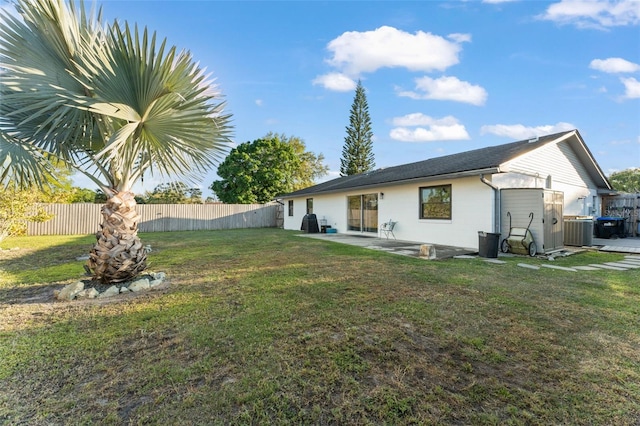 back of house with a patio, a lawn, central AC unit, and a fenced backyard