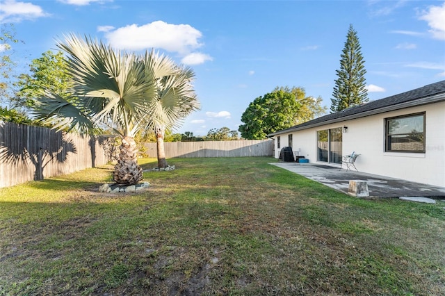 view of yard with a patio area and a fenced backyard