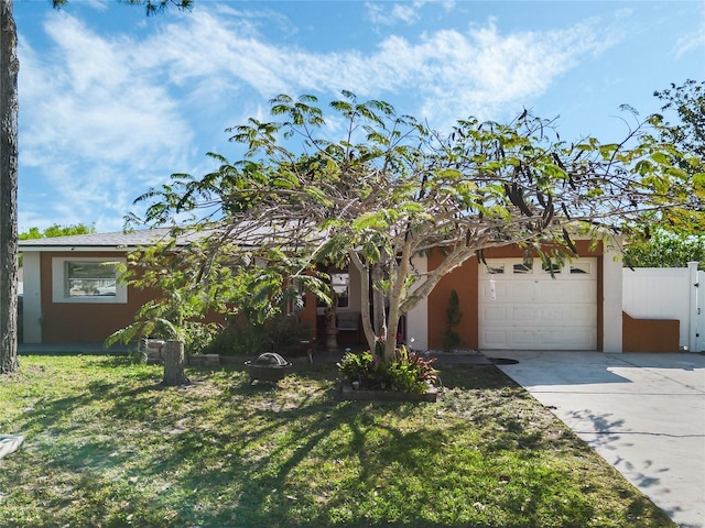 view of front of property featuring fence, a front yard, stucco siding, driveway, and an attached garage