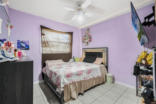 bedroom with light tile patterned floors, baseboards, and a ceiling fan