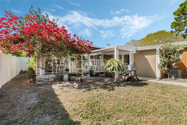 view of yard with a patio area, fence, and central AC