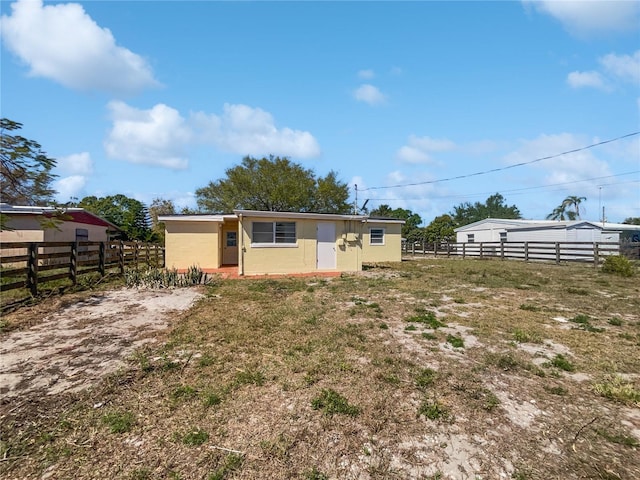 exterior space with an outbuilding and fence