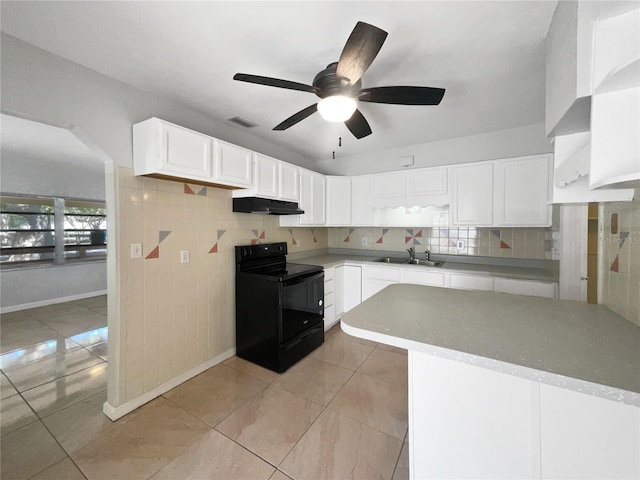 kitchen with visible vents, black electric range, under cabinet range hood, a sink, and backsplash