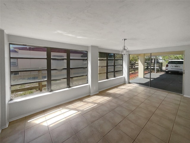 unfurnished sunroom with a chandelier