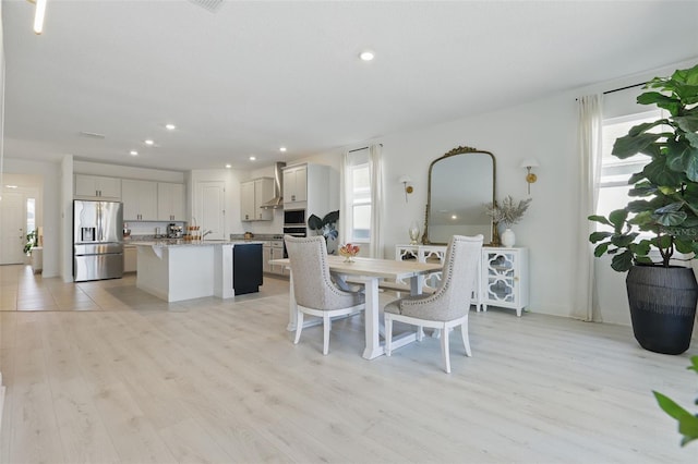 dining space with recessed lighting, plenty of natural light, and light wood-style flooring