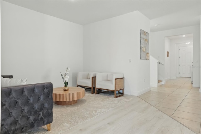 sitting room featuring light wood finished floors and baseboards