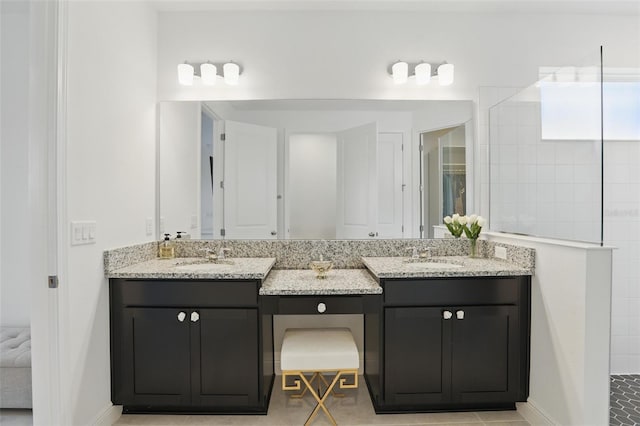 bathroom featuring a sink, two vanities, and a walk in shower