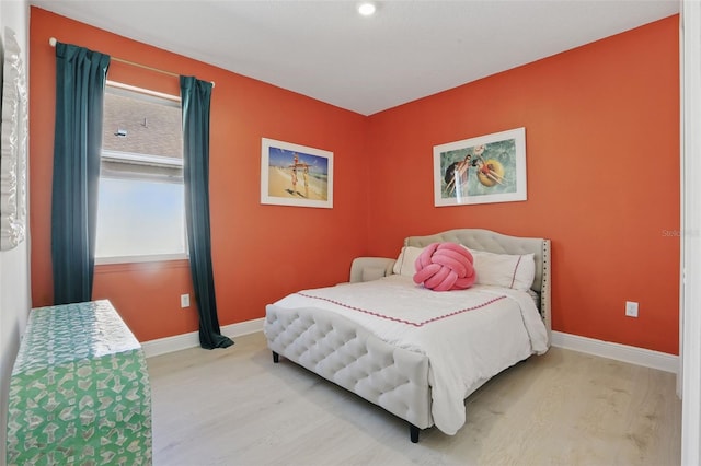 bedroom with baseboards and wood finished floors