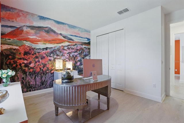 office area with visible vents, wallpapered walls, baseboards, and wood finished floors