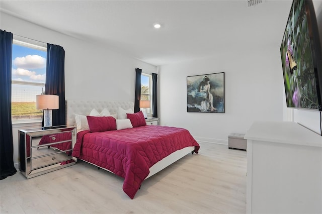 bedroom featuring recessed lighting, baseboards, and light wood-type flooring