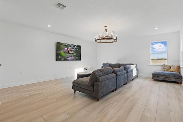 living room with light wood finished floors, visible vents, baseboards, a chandelier, and recessed lighting