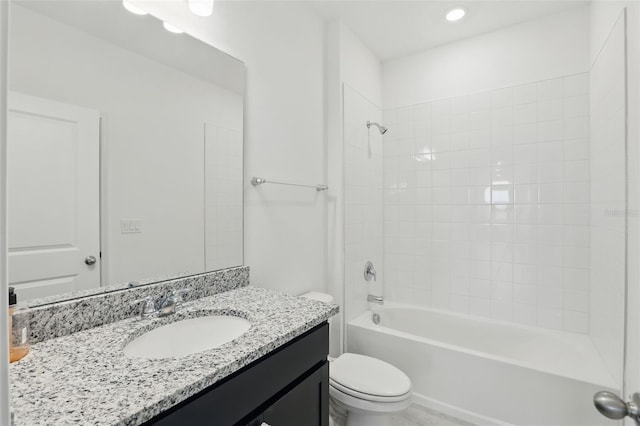 bathroom with toilet, vanity, and shower / bathing tub combination