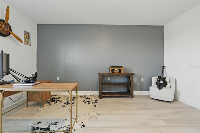 home office featuring baseboards and wood finished floors