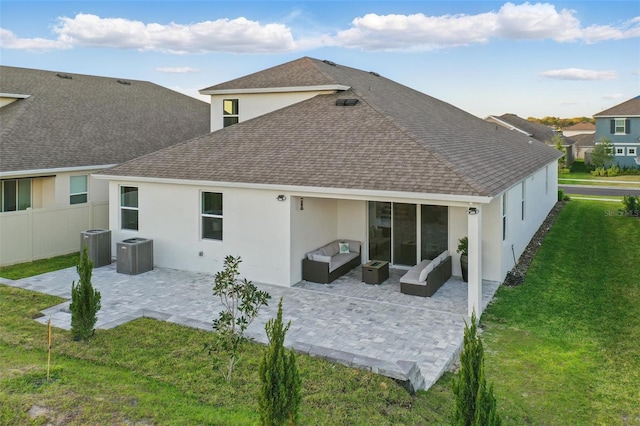 back of house featuring a yard, outdoor lounge area, a patio, and roof with shingles