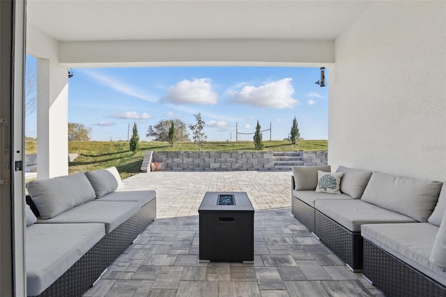 view of patio / terrace featuring an outdoor living space with a fire pit