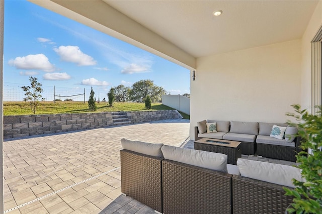 view of patio featuring an outdoor living space and fence