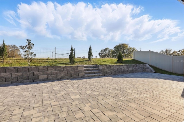 view of patio featuring fence