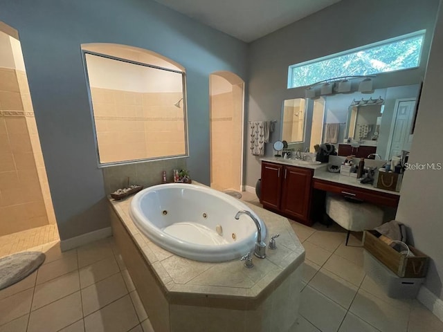 full bathroom featuring tile patterned flooring, a jetted tub, vanity, and walk in shower