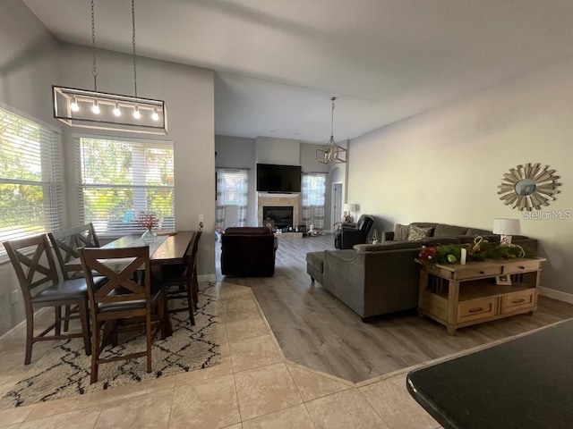 dining space featuring tile patterned flooring, baseboards, and a tile fireplace