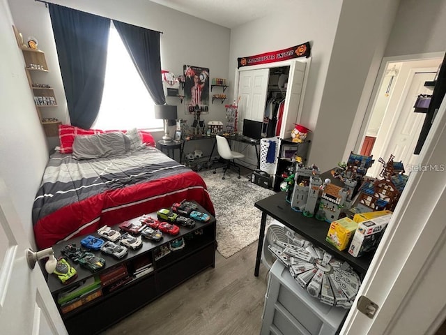 bedroom with a closet and wood finished floors