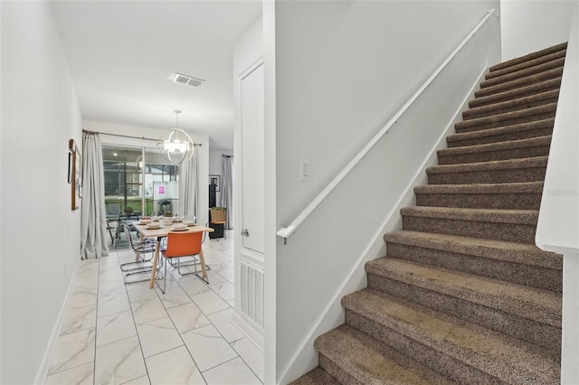 staircase with visible vents, marble finish floor, and baseboards